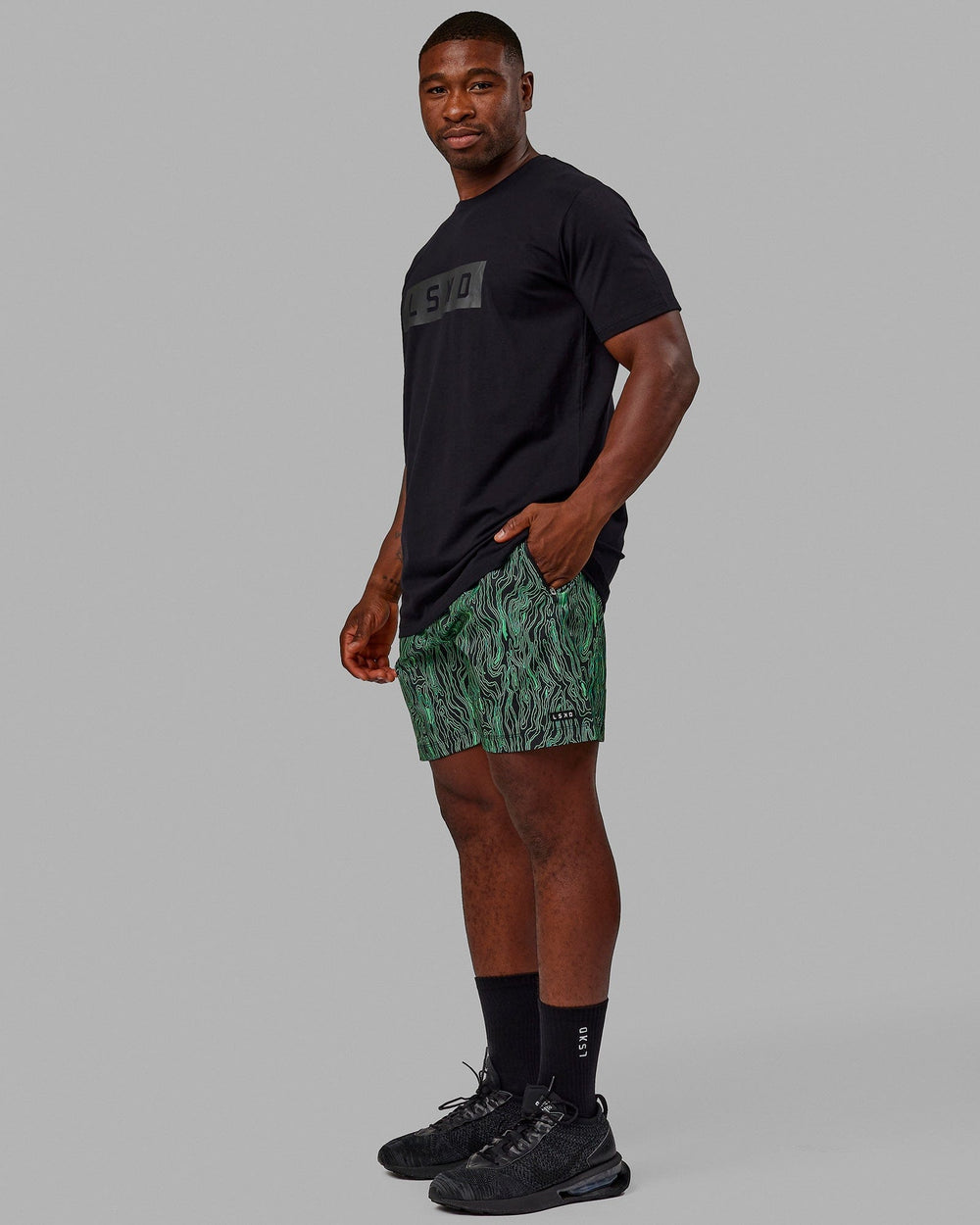 Man wearing Rep 7'' Performance Shorts - Topographic Black-Lime