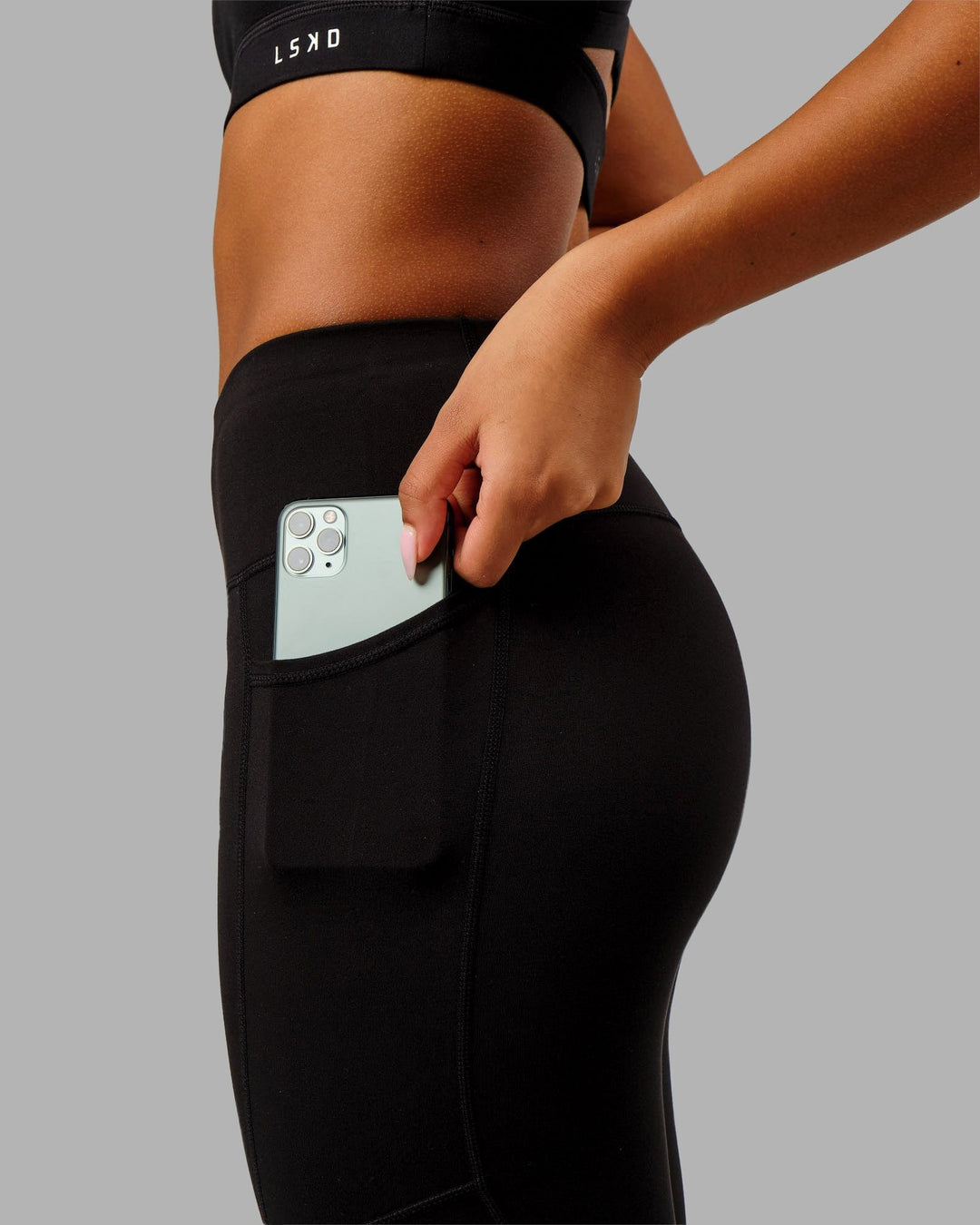 Woman wearing Rep Ultra High-Rise 7/8 Legging Pockets - Black-Black | Model:Isabella | Size:S