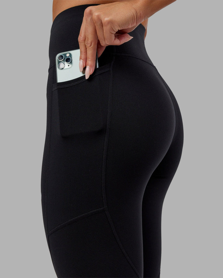 Woman wearing Rep 7/8 Length Tight - Black-Hyper Teal