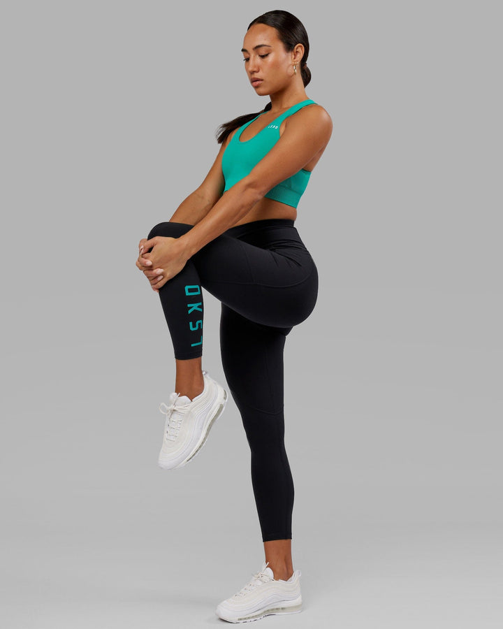 Woman wearing Rep 7/8 Length Tight - Black-Hyper Teal