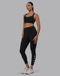Woman wearing Rep Ultra High-Rise 7/8 Legging Pockets - Pirate Black-White | Model:Blaize | Size:S