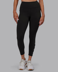Woman wearing Rep Ultra High-Rise 7/8 Legging Pockets - Pirate Black-White | Model:Blaize | Size:S
