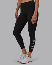Woman wearing Rep Ultra High-Rise 7/8 Legging Pockets - Pirate Black-White | Model:Blaize | Size:S