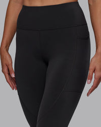 Woman wearing Rep Ultra High-Rise 7/8 Legging Pockets - Pirate Black-White | Model:Blaize | Size:S