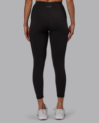 Woman wearing Rep Ultra High-Rise 7/8 Legging Pockets - Pirate Black-White | Model:Blaize | Size:S