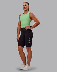 Woman wearing Rep Ultra High-Rise 9" Short Pockets - Black-Surreal Green | Model:Amber | Size:S