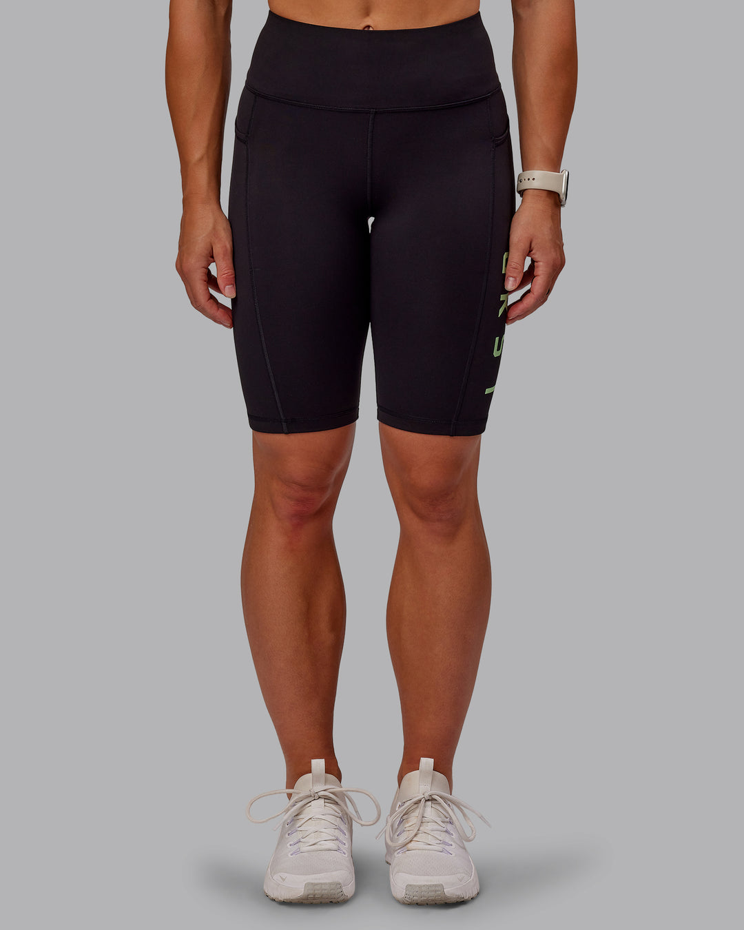 Woman wearing Rep Ultra High-Rise 9" Short Pockets - Black-Surreal Green | Model:Amber | Size:S