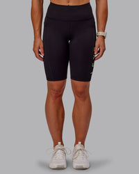 Woman wearing Rep Ultra High-Rise 9" Short Pockets - Black-Surreal Green | Model:Amber | Size:S
