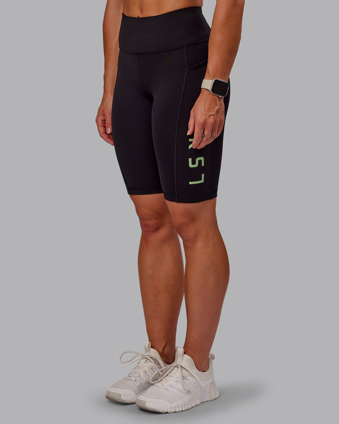 Woman wearing Rep Ultra High-Rise 9" Short Pockets - Black-Surreal Green | Model:Amber | Size:S