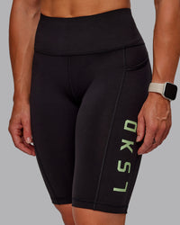 Woman wearing Rep Ultra High-Rise 9" Short Pockets - Black-Surreal Green | Model:Amber | Size:S