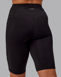 Woman wearing Rep Ultra High-Rise 9" Short Pockets - Black-Surreal Green | Model:Amber | Size:S
