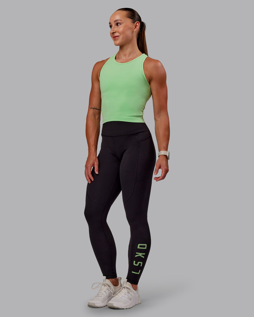 Woman wearing Rep Ultra High-Rise Full Length Legging Pockets - Black-Surreal Green | Model:Amber | Size:S