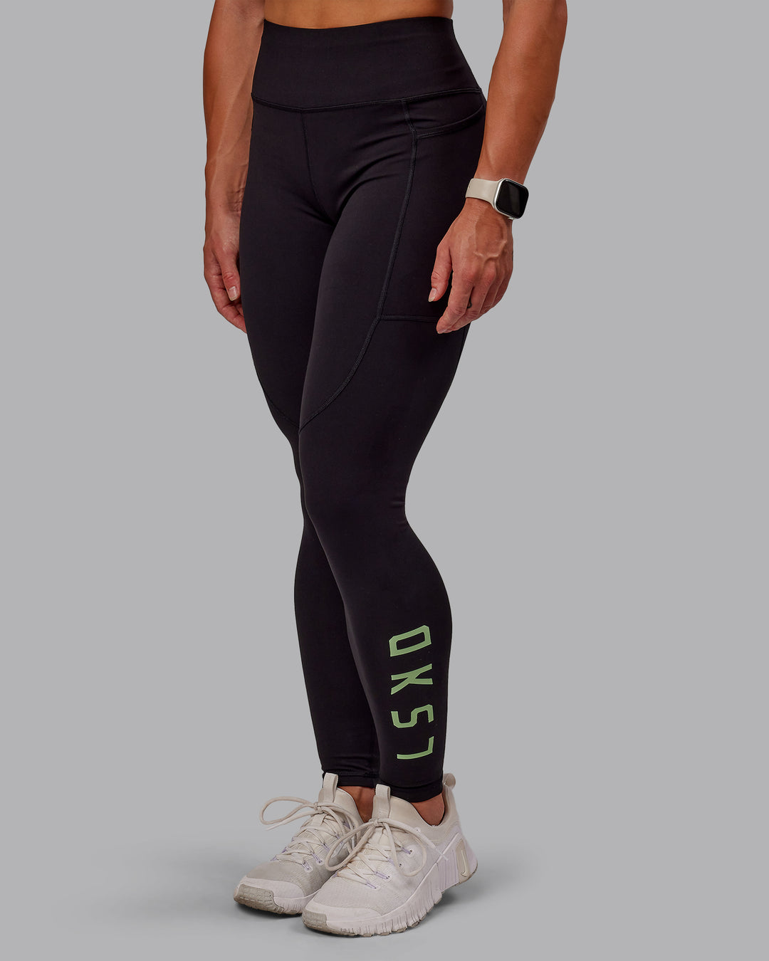 Woman wearing Rep Ultra High-Rise Full Length Legging Pockets - Black-Surreal Green | Model:Amber | Size:S