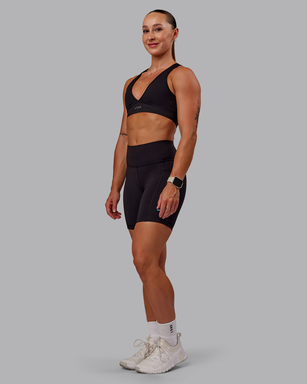 Woman wearing Rep Ultra High-Rise 6&quot; Short Pockets - Black-Azure Blue | Model:Amber | Size:S