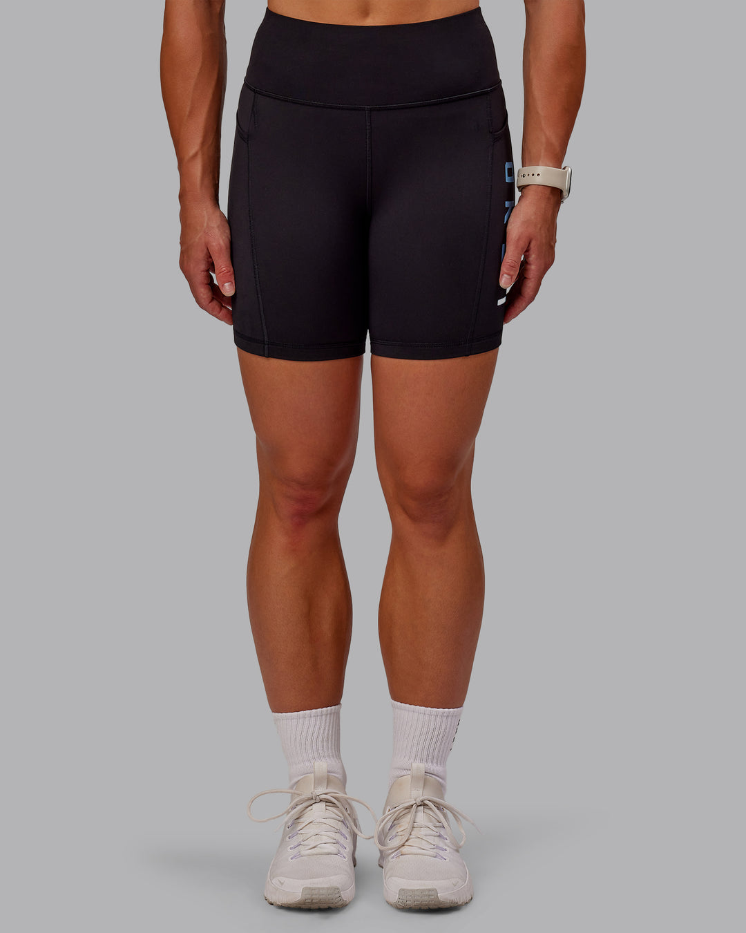 Woman wearing Rep Ultra High-Rise 6&quot; Short Pockets - Black-Azure Blue | Model:Amber | Size:S