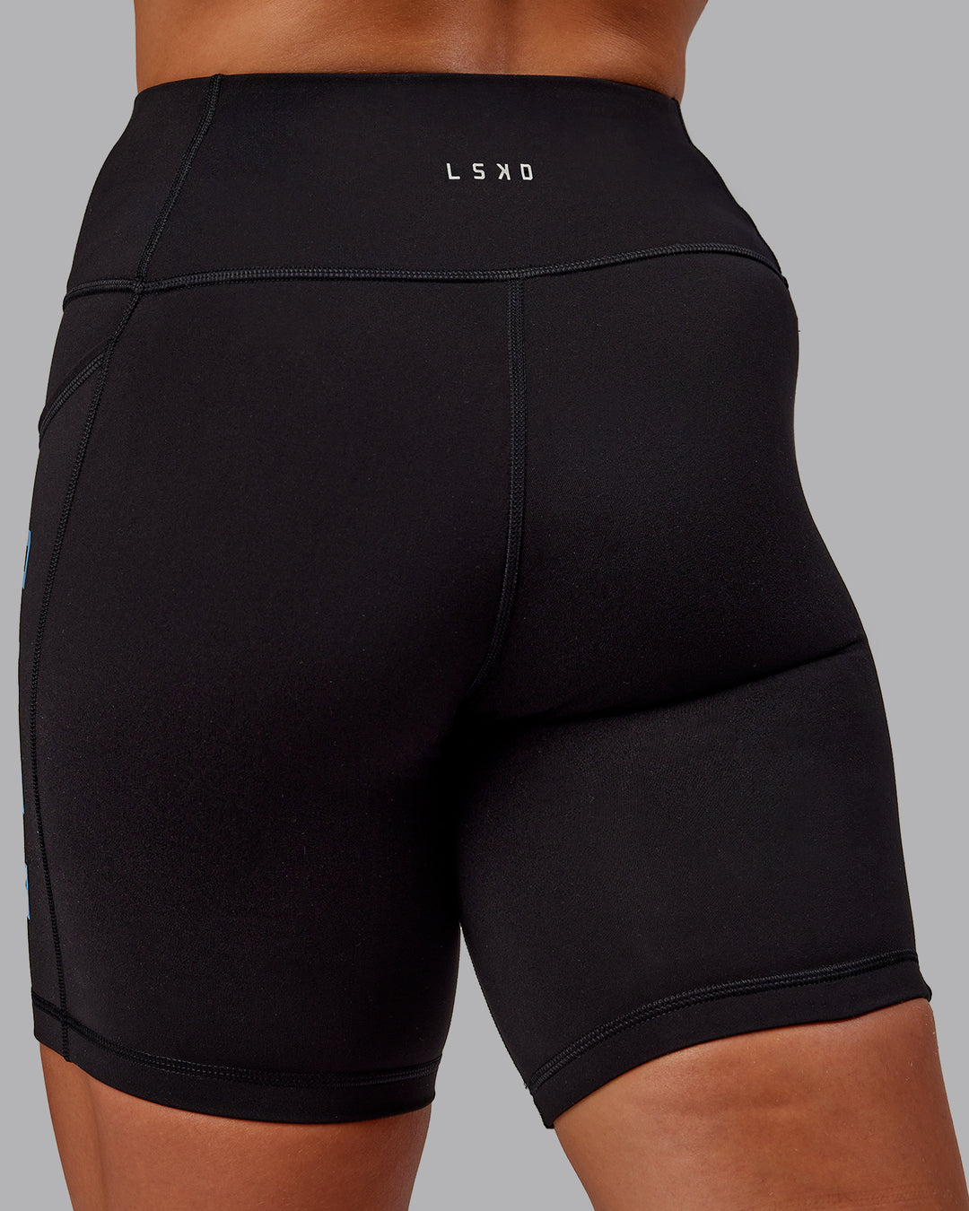 Woman wearing Rep Ultra High-Rise 6&quot; Short Pockets - Black-Azure Blue | Model:Amber | Size:S