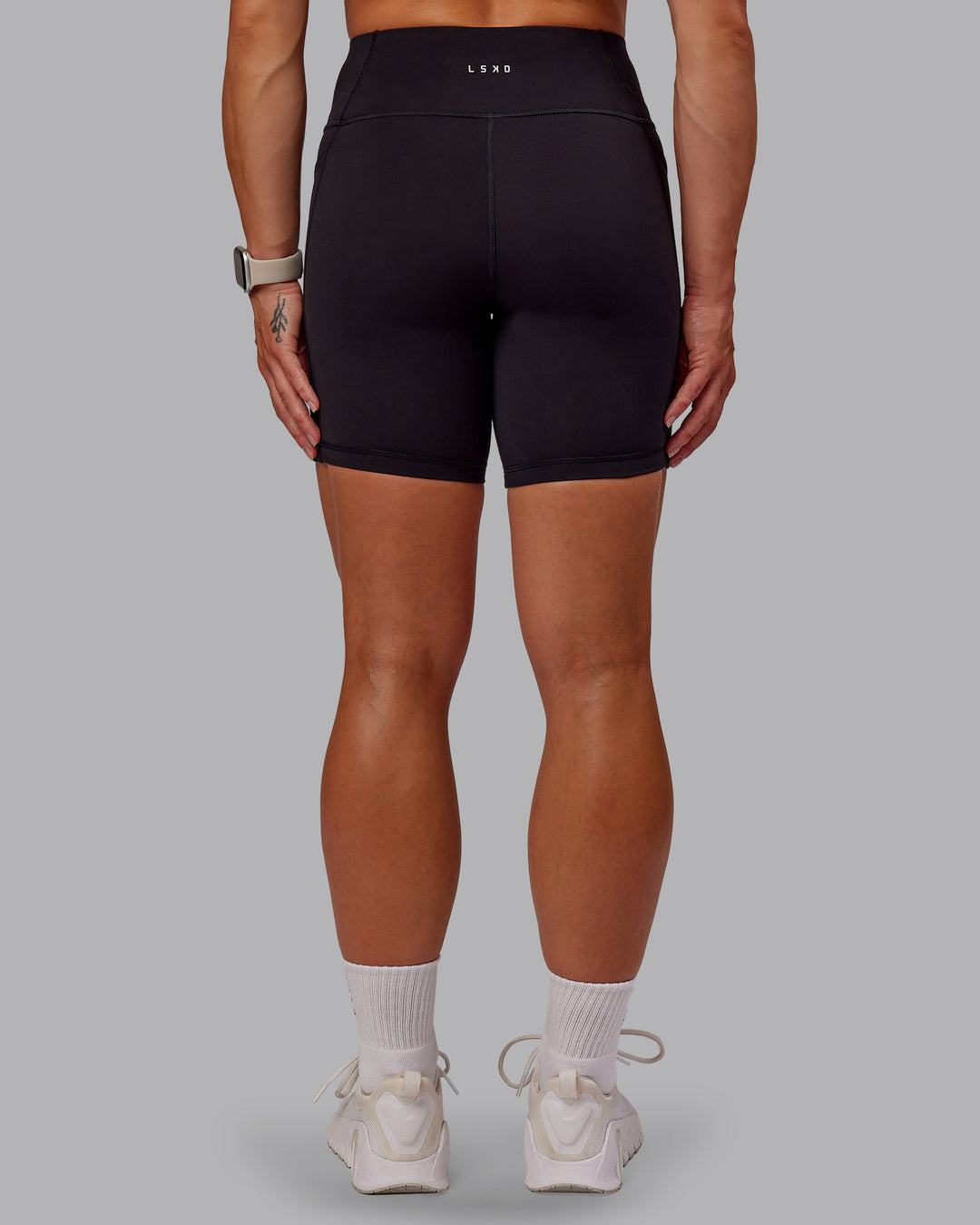 Woman wearing Rep Ultra High-Rise 6&quot; Short Pockets - Black-Azure Blue | Model:Amber | Size:S
