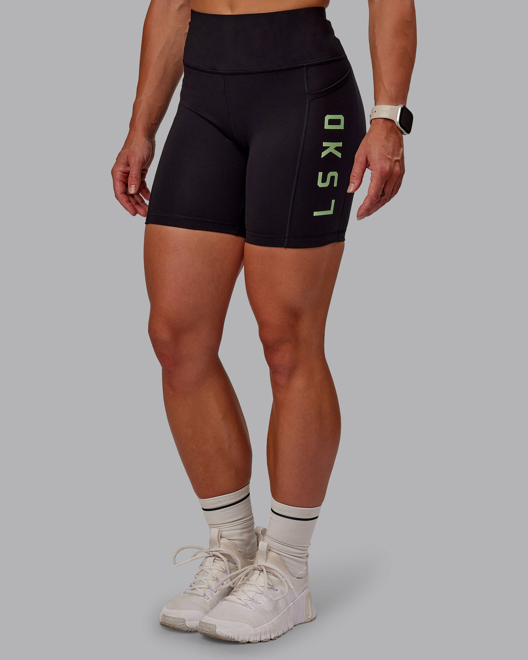 Woman wearing Rep Ultra High-Rise 6" Short Pockets - Black-Surreal Green | Model:Amber | Size:S