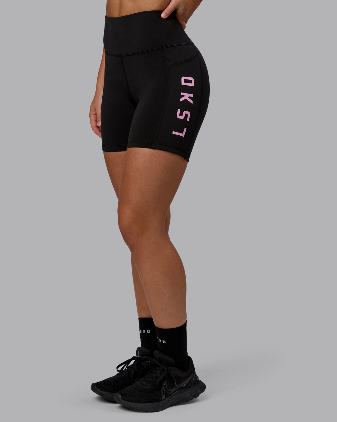 Woman wearing Rep Ultra High-Rise 6" Short Pockets - Black-Bubblegum | Model:Monique | Size:S