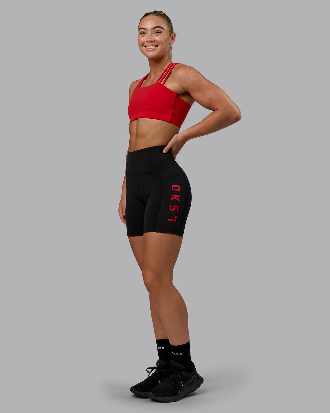 Woman wearing Rep Ultra High-Rise 6&quot; Short Pockets - Black-Crimson | Model:Monique | Size:S