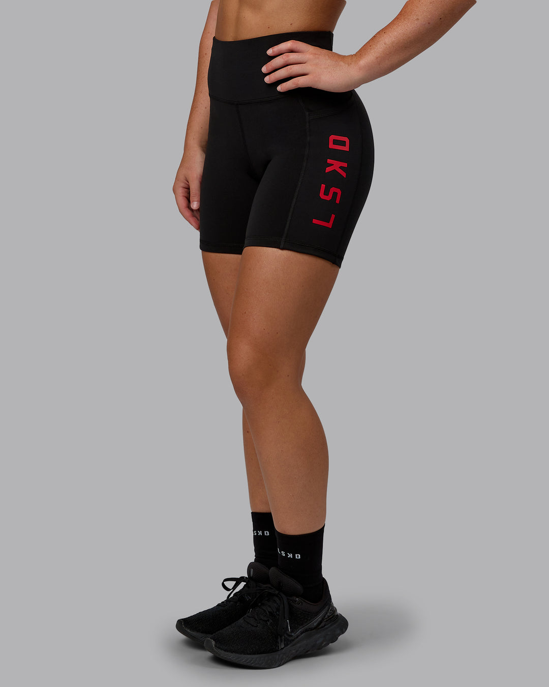 Woman wearing Rep Ultra High-Rise 6&quot; Short Pockets - Black-Crimson | Model:Monique | Size:S