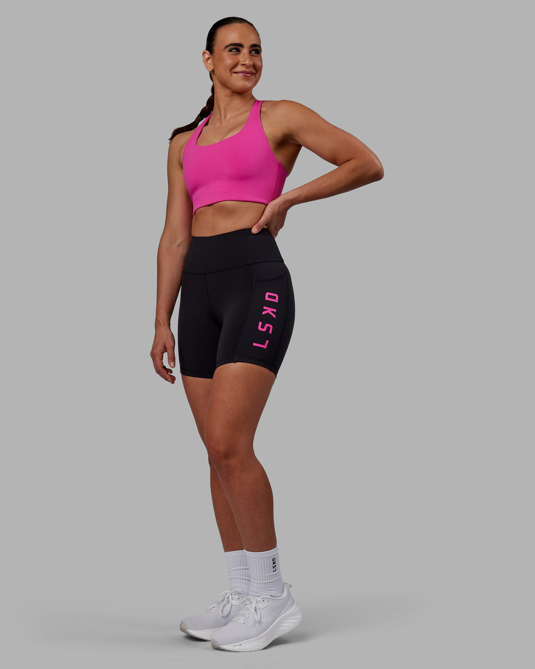 Woman wearing Rep Ultra High-Rise 6&quot; Short Pockets - Black-Fuchsia Pink | Model:Sophie | Size:S