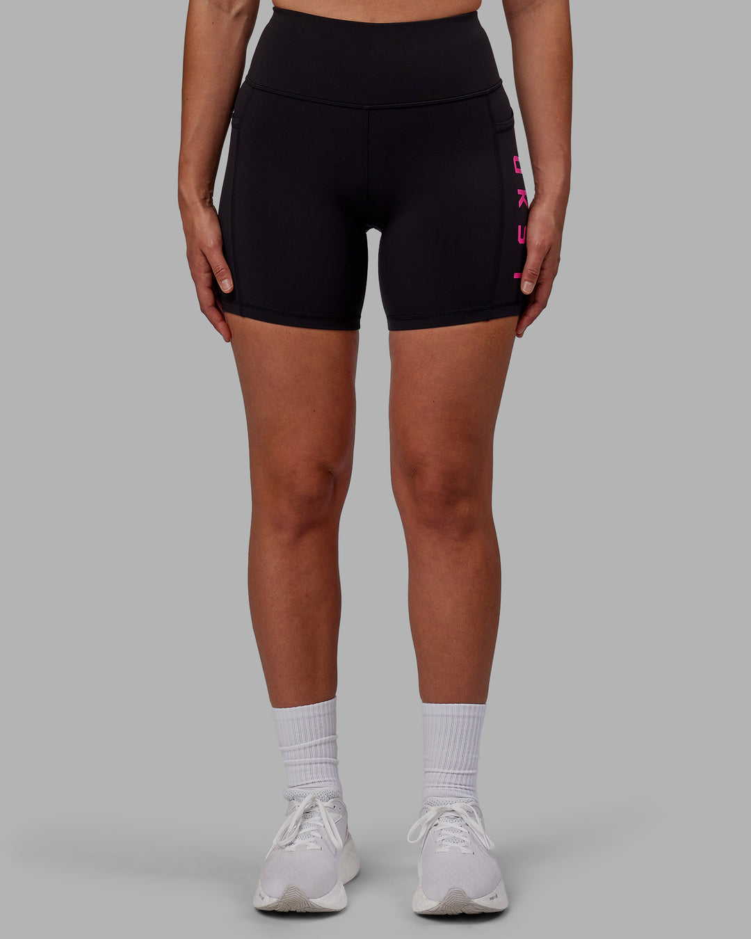 Woman wearing Rep Ultra High-Rise 6&quot; Short Pockets - Black-Fuchsia Pink | Model:Sophie | Size:S