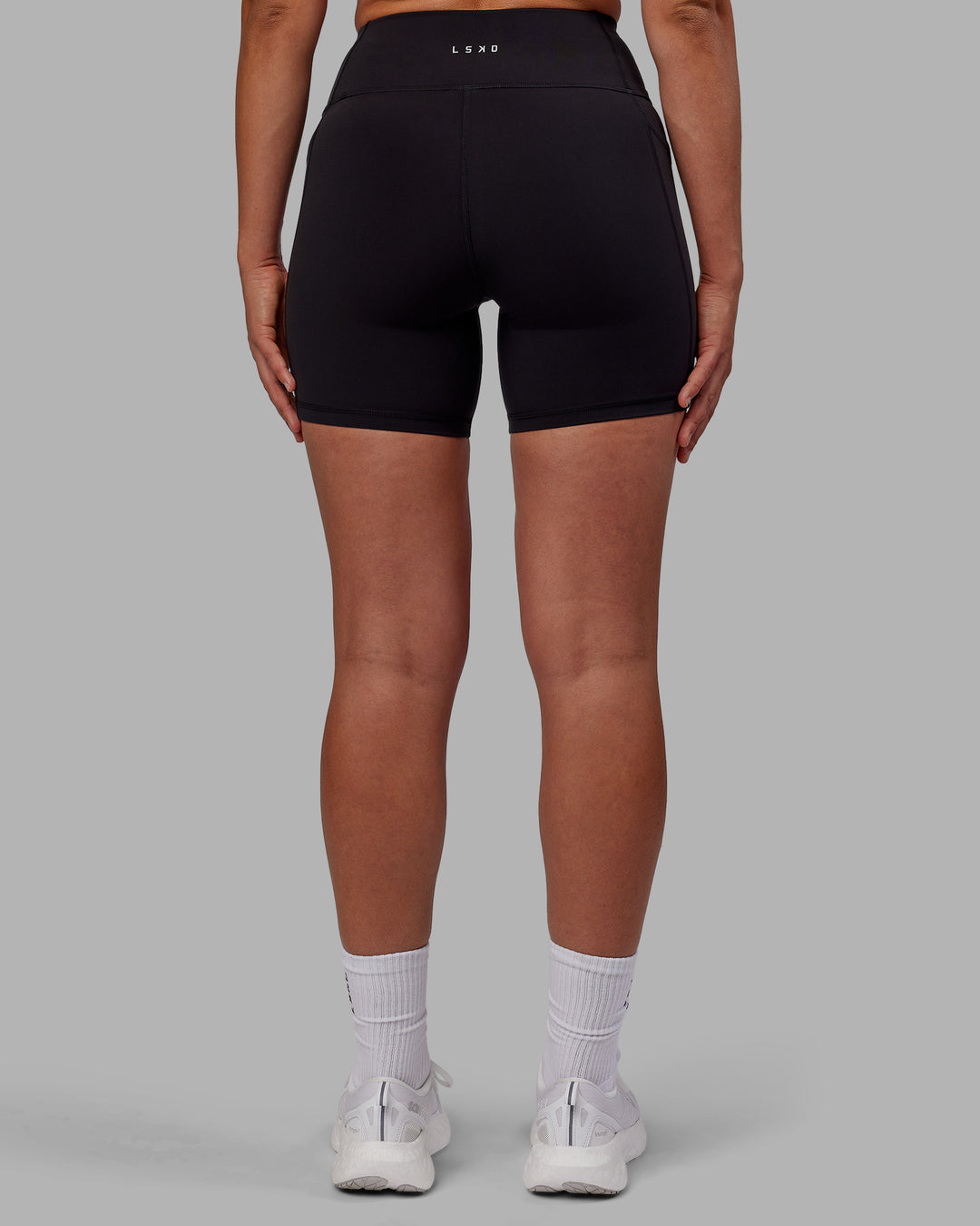 Woman wearing Rep Ultra High-Rise 6&quot; Short Pockets - Black-Fuchsia Pink | Model:Sophie | Size:S
