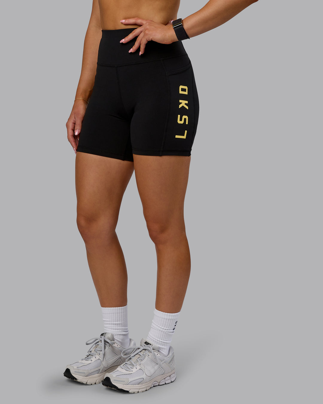 Woman wearing Rep Ultra High-Rise 6" Short Pockets - Black-Lemon | Model:Halle | Size:S