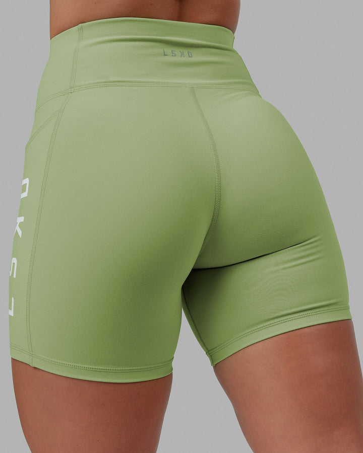 Woman wearing Rep Mid Short Tights - Green Fig