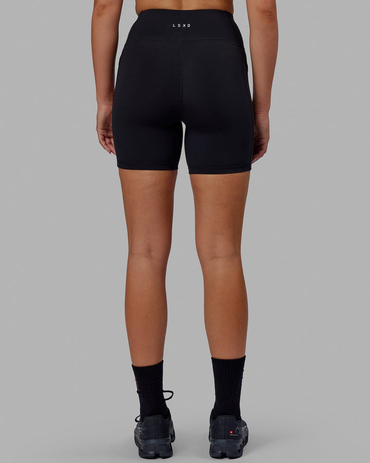 Woman wearing Rep Mid Short Tights - Black-Raspberry