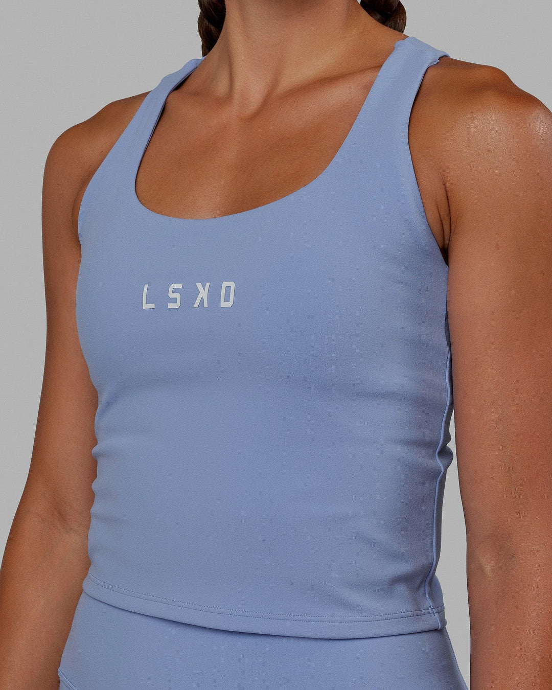 Woman wearing Rep Shelf Bra Performance Tank - Arctic Blue