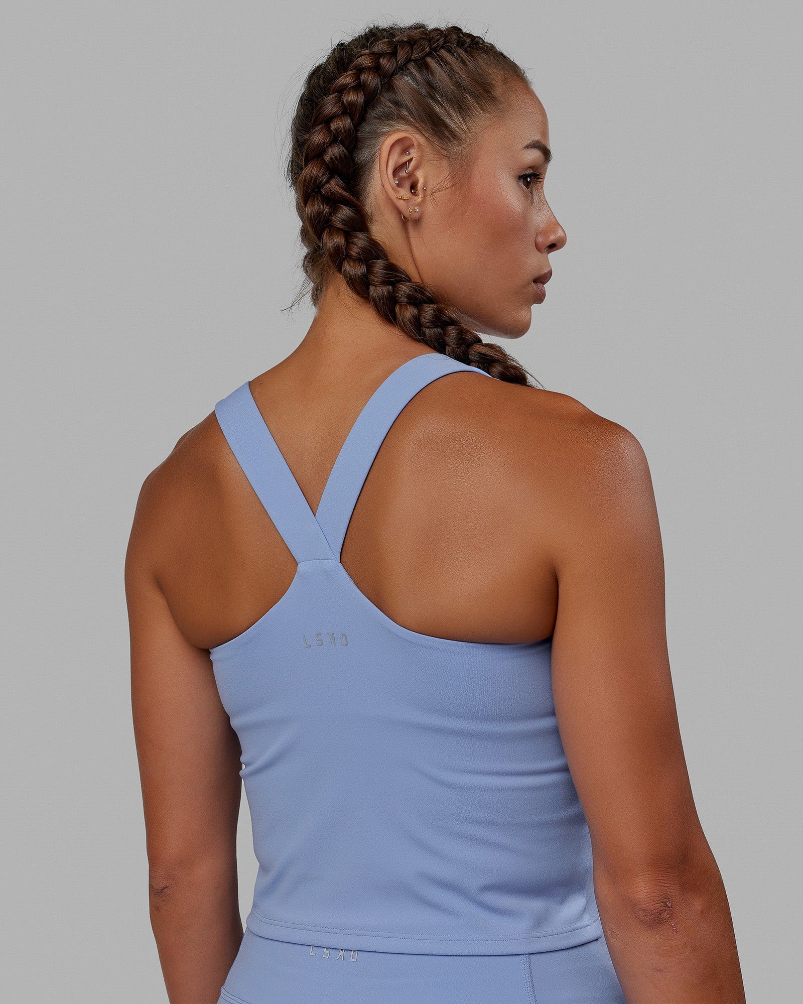 Woman wearing Rep Shelf Bra Performance Tank - Arctic Blue