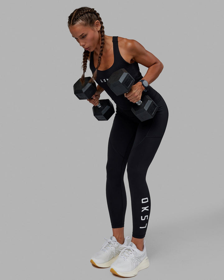 Woman wearing Rep Shelf Bra Performance Tank - Black