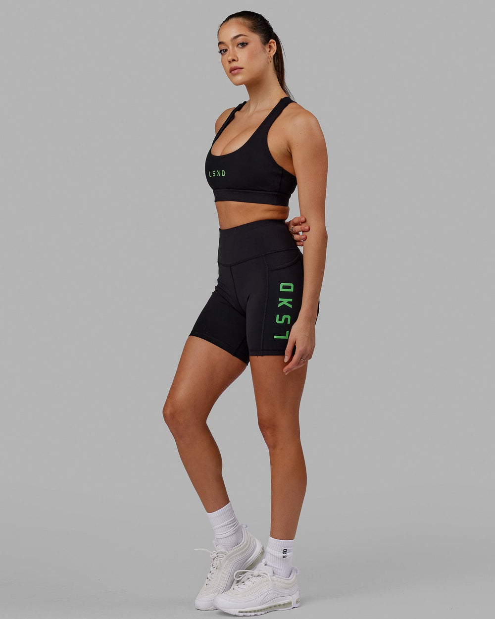 Woman wearing Rep Sports Bra Small Logo - Black-Apple Mint