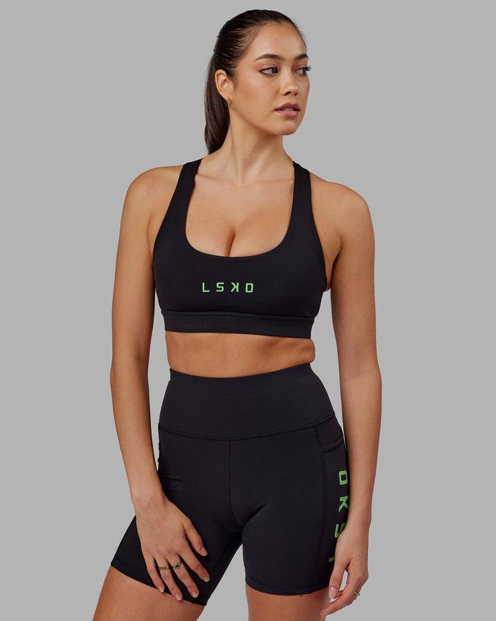 Woman wearing Rep Sports Bra Small Logo - Black-Apple Mint