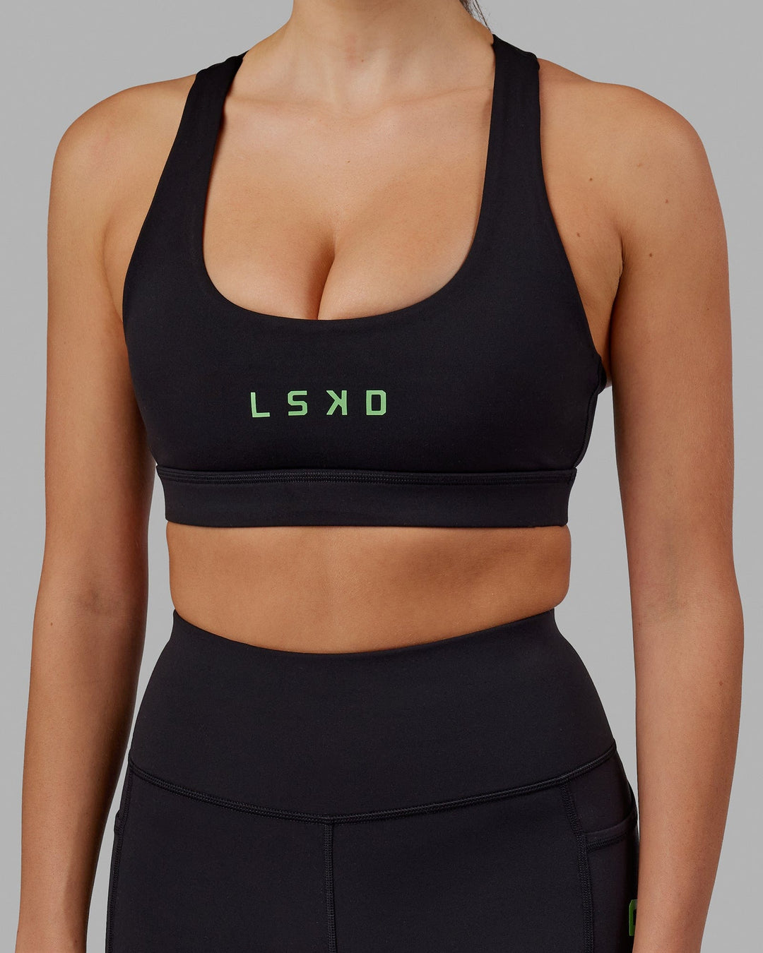 Woman wearing Rep Sports Bra Small Logo - Black-Apple Mint
