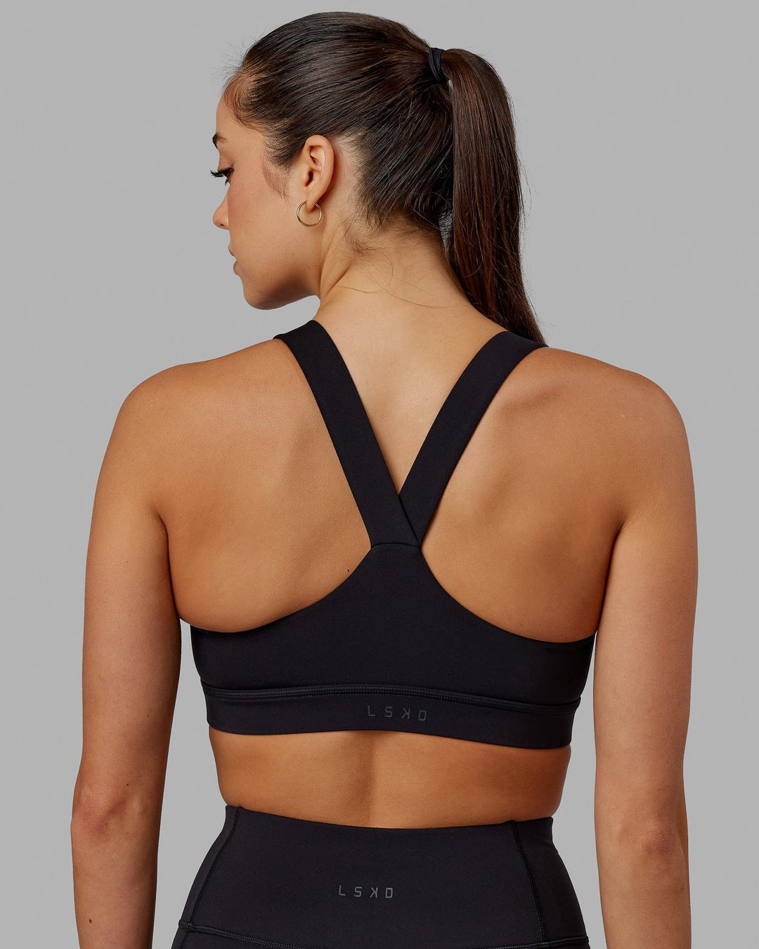 Woman wearing Rep Sports Bra Small Logo - Black-Apple Mint