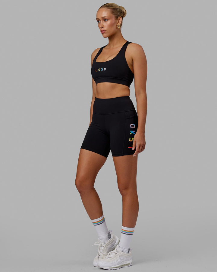 Woman wearing Rep Sports Bra Small Logo - Pride-Black