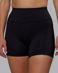 Woman wearing Rep Ultra High-Rise 4" Short Pockets - Black-Black | Model:Lillie | Size:S
