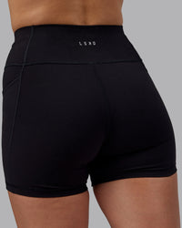 Woman wearing Rep Ultra High-Rise 4" Short Pockets - Black-Black | Model:Lillie | Size:S