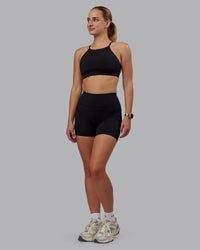Woman wearing Rep Ultra High-Rise 4" Short Pockets - Black-Black | Model:Lillie | Size:S