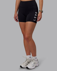 Woman wearing Rep Ultra High-Rise 4" Short Pockets - Black-White | Model:Lillie | Size:S