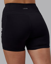 Woman wearing Rep Ultra High-Rise 4" Short Pockets - Black-White | Model:Lillie | Size:S