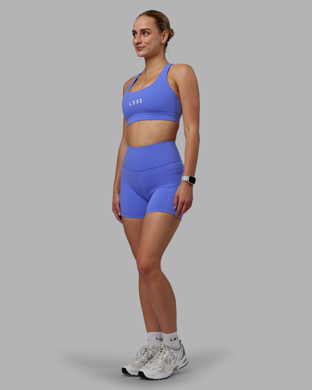 Woman wearing Rep Ultra High-Rise 4&quot; Short Pockets - Baja Blue-White | Model:Lillie | Size:S