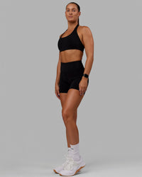 Woman wearing O.G. Rep Ultra High-Rise 4" Short Pockets - Black-Black | Model:Abbey| Size:S