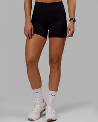 Woman wearing O.G. Rep Ultra High-Rise 4" Short Pockets - Black-Black | Model:Abbey| Size:S