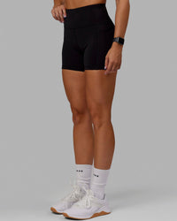 Woman wearing O.G. Rep Ultra High-Rise 4" Short Pockets - Black-Black | Model:Abbey| Size:S