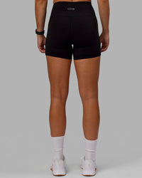 Woman wearing O.G. Rep Ultra High-Rise 4" Short Pockets - Black-Black | Model:Abbey| Size:S