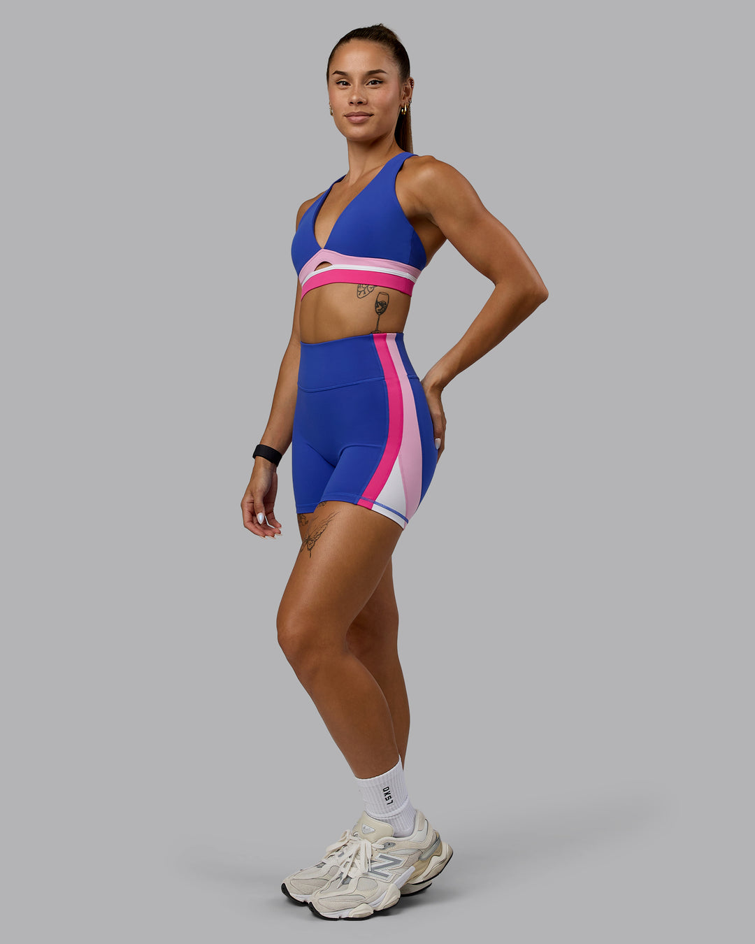 Woman wearing Revitalise Sports Bra - Power Cobalt-Fuchsia Pink